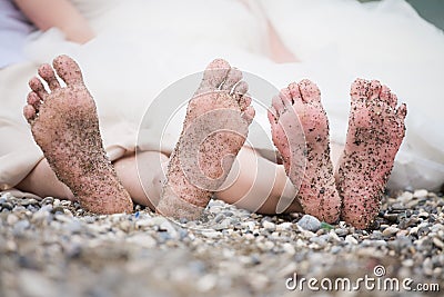 Pair of feet with stones and send Stock Photo