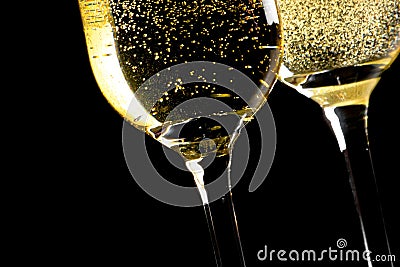 A pair of flutes of champagne tilted with golden bubbles Stock Photo