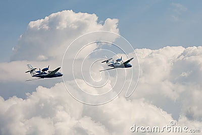 Pair of the Flying airplane Be-103 in clouds Editorial Stock Photo
