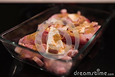 Pair of fresh rabbit thighs and parts seasoned with indian style curry and butter Stock Photo