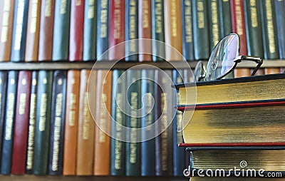 A Pair of Glasses on a Stack of Books Stock Photo