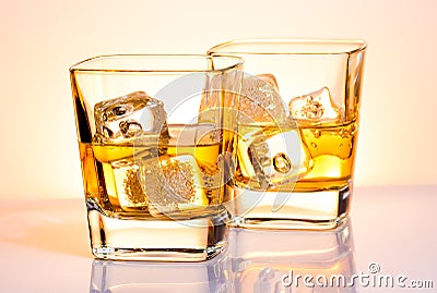 A pair of glasses of whiskey with ice Stock Photo