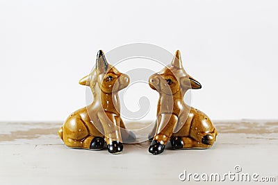 Pair of golden brown horse/donkey salt and pepper shakers on white background. Stock Photo