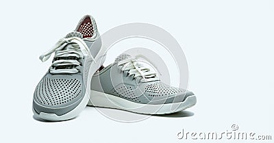 A pair of grey shoes on white background. Comfortable shoes with pore. Breathable rubber shoes. Footwear Stock Photo