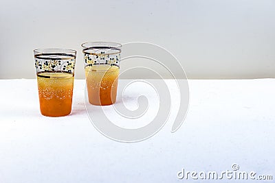 A pair hand crafted yellow orange vintage drinking glasses Stock Photo