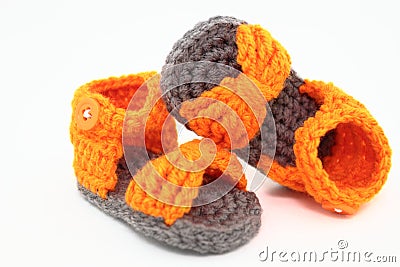 A Pair Of Handcrafted Baby Sandals In Orange And Gray Stock Photo