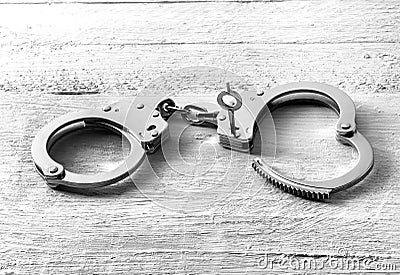 Pair of handcuffs with one side unlocked Stock Photo