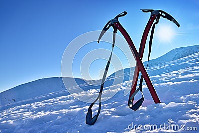 Pair of ice axes on mountain slope Stock Photo