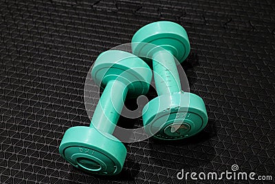 A pair of 1kg. dumbbells in green color. Stock Photo