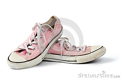 Pair of light pink worn textile sneakers with laces isolated on a white background Stock Photo