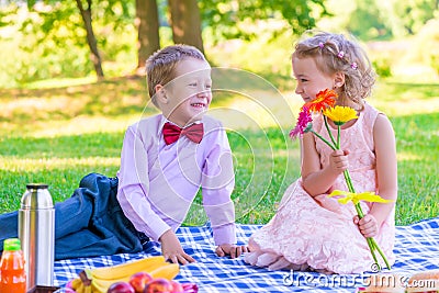 Pair of lovers of children at the picnic on the lawn Stock Photo