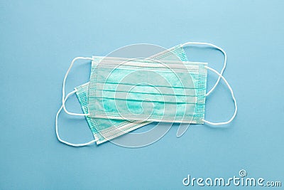pair of medical surgical protective masks on pastel blue background Stock Photo