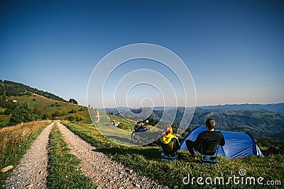 A pair of motorcyclists enjoy the view, man and woman. Loving couple of tourists. Relationship and adventure concept. A touring Stock Photo