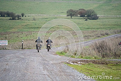 Pair of motorcyclists riding on an off-road bike in a rural area in Salisbury, UK Editorial Stock Photo