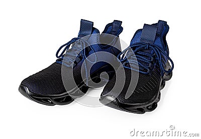 Pair of new grooved sneakers isolated on a white background. Textile sport shoes with laced fastening cutout. Black blue mesh Stock Photo