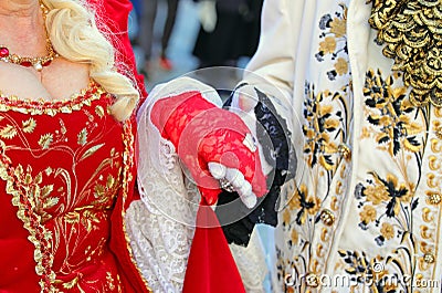 Noble Lovers Holding Hands in Ancient and Luxurious Aristocratic Clothes during Masquerade Ball Stock Photo