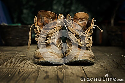 Pair of old boots on wooden floor boards Stock Photo