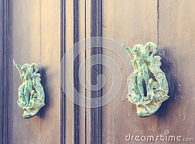 A Pair of Old Metal Poseidon Shaped Knockers on Wooden Door in M Stock Photo