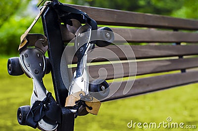 Pair of old roller skate hanging on the bench. Sport for all times Stock Photo