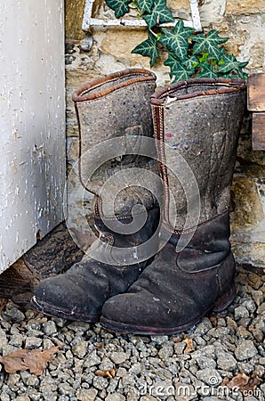 Pair of old vintage used winter high knee boots made of felt and leather Stock Photo