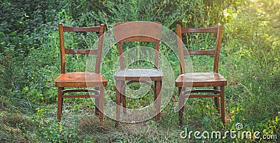 Pair old wooden chair outdoors. Two wooden folding chairs for rest. Stock Photo