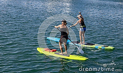 A Pair of Paddle Boarders Editorial Stock Photo