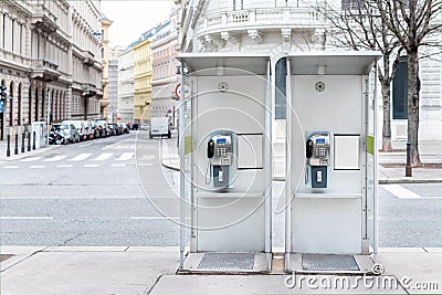 Pair of payphone booth in Vienna center street. Two modern public phones on european city street. copyspace Stock Photo