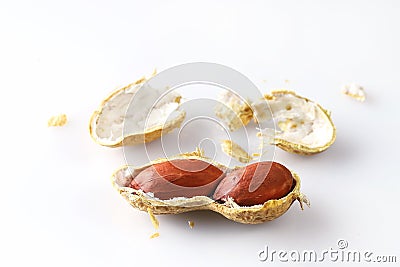 Pair of peanut nuts are in half shell with fragments, isolated on white background Stock Photo