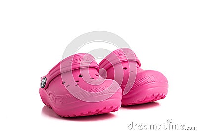 Pair of pink baby Crocs sandals isolated on white background. Close-up Editorial Stock Photo