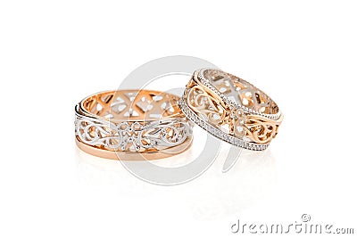 Pair of pink gold and white gold wedding ring with ornament isolated on white Stock Photo