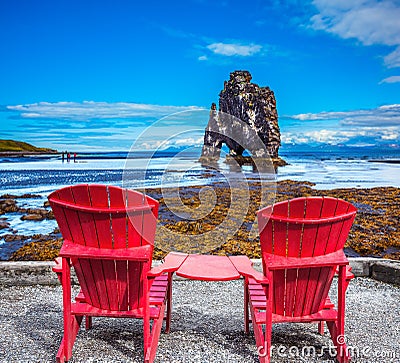 Pair of red deck chairs and Rock Hvitsercur Stock Photo