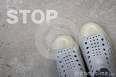 Pair of shoes standing on a road with STOP concept Stock Photo