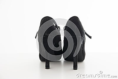 Pair of slightly used high heel stiletto woman`s shoes close up studio shot isolated on white Stock Photo