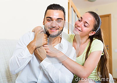 Pair smiling and embracing indoors Stock Photo