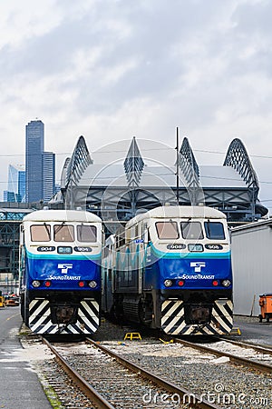 Pair of Sound Transit commuter trains in front of the Seattle skyline Editorial Stock Photo