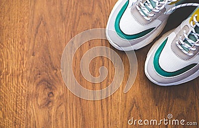 Pair of sport shoes on wooden background. New sneakers and space for ad text Stock Photo