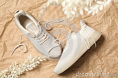 Pair of stylish shoes with laces on crumpled craft paper, flat lay Stock Photo