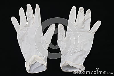 Pair of two medical white rubber gloves on black background. Stock Photo