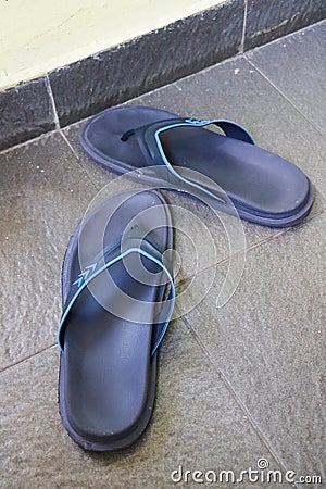 Closeup photo of Navy blue rubber flip-flops Stock Photo