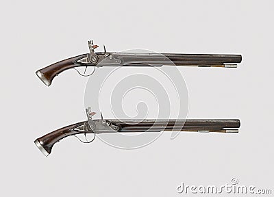 Pair of vintage pistols or muskets on a white bac Editorial Stock Photo