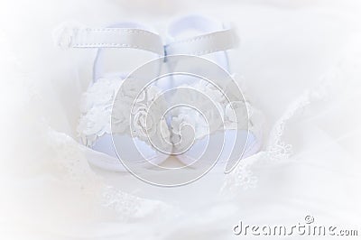 Pair of white baby shoes , christening white dress Stock Photo