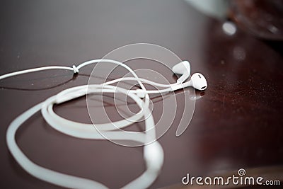 White earphone on the wooden table Stock Photo