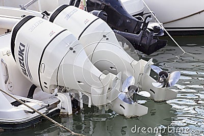 Pair white marine engines outboard model Suzuki 200 mounted on a white fiberglass pleasure boat Editorial Stock Photo