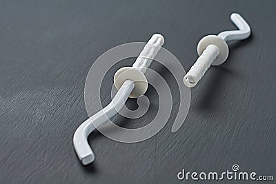 Pair of white new modern hooks for mount aluminum or bimetallic radiator for heating house Stock Photo