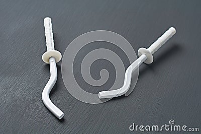 Pair of white new modern hooks for mount aluminum or bimetallic radiator for heating house Stock Photo