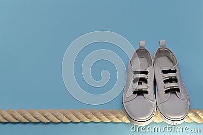 A pair of athletic shoes and a rope. Stock Photo