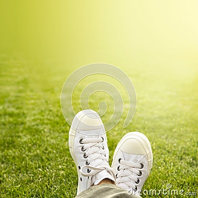 A pair of white trainers in the grass in the sunshine Stock Photo