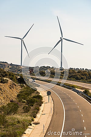 A pair of windmills in the Sierra del Merengue wind farm next to the Ruta de la Plata highway passing through Plasencia Editorial Stock Photo