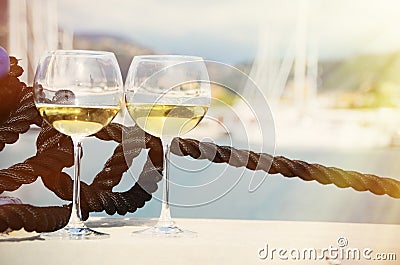 Pair of wineglasses against yachts Stock Photo