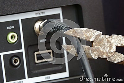 Cutting the Cable TV Cord With a Wire Cutter Tool Stock Photo